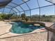 Inviting freeform pool with water features and screened enclosure at 14462 Fort Worth Cir, Port Charlotte, FL 33981