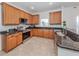 Modern kitchen with wood cabinets, granite countertops, and stainless steel appliances at 14462 Fort Worth Cir, Port Charlotte, FL 33981