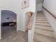 Staircase with wood railing leading to upper level at 14462 Fort Worth Cir, Port Charlotte, FL 33981