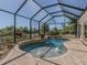 Stunning freeform pool with water features and screened enclosure at 14462 Fort Worth Cir, Port Charlotte, FL 33981