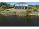 An aerial view of a home with a screened-in pool and lanai at 14462 Fort Worth Cir, Port Charlotte, FL 33981