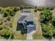 Aerial view of a house near the water with a pool and a large backyard at 14462 Fort Worth Cir, Port Charlotte, FL 33981
