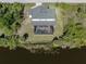 Aerial view showcasing a house, private pool, and serene canal views at 14462 Fort Worth Cir, Port Charlotte, FL 33981