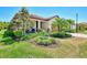 One-story house with tile roof, landscaping, and brown garage door at 12297 Canavese Ln, Venice, FL 34293