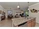 Modern kitchen with granite countertop and stainless steel dishwasher at 12297 Canavese Ln, Venice, FL 34293