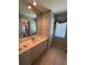 Well-lit bathroom with a single sink vanity and linen closet at 2454 Sonoma W Dr, Nokomis, FL 34275