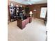 Bright home office with a large desk and built-in bookshelves at 2454 Sonoma W Dr, Nokomis, FL 34275