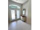 Bright entryway with double doors and antique dresser at 2454 Sonoma W Dr, Nokomis, FL 34275