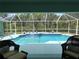 Refreshing swimming pool with screened enclosure and lush landscaping at 2454 Sonoma W Dr, Nokomis, FL 34275