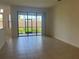 Bright Gathering room with sliding glass doors leading to a screened patio at 1498 Maseno Dr, Venice, FL 34292