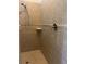Tiled shower with built-in seat and shower head at 1498 Maseno Dr, Venice, FL 34292