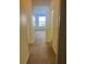 Hallway leading to a bedroom with carpet flooring at 1498 Maseno Dr, Venice, FL 34292