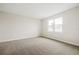 Spacious bedroom with neutral carpeting and large window at 16090 Highgate St, Port Charlotte, FL 33953