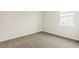 Bright bedroom with carpeted floor and a window at 16090 Highgate St, Port Charlotte, FL 33953