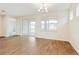 Spacious dining area with wood-look tile flooring and access to backyard patio at 16090 Highgate St, Port Charlotte, FL 33953