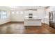 Open concept kitchen with white cabinets and granite countertops at 16090 Highgate St, Port Charlotte, FL 33953