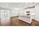 Modern kitchen with white cabinets, granite island, and stainless steel appliances at 16090 Highgate St, Port Charlotte, FL 33953