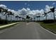 Palm tree-lined entrance road into community at 15177 Spanish Point Dr, Port Charlotte, FL 33981