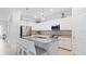 Modern kitchen with white cabinets, granite countertops, and stainless steel appliances at 15177 Spanish Point Dr, Port Charlotte, FL 33981