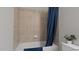 Bathroom with a shower/tub combo and blue shower curtain at 15177 Spanish Point Dr, Port Charlotte, FL 33981