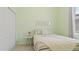 Light green bedroom with a double bed and a small side table at 15177 Spanish Point Dr, Port Charlotte, FL 33981