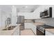 Modern kitchen with stainless steel appliances and granite countertops at 15177 Spanish Point Dr, Port Charlotte, FL 33981