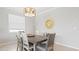 Dining room with wood table, six chairs, and stylish light fixture at 15177 Spanish Point Dr, Port Charlotte, FL 33981