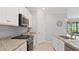 Modern kitchen with white cabinets, granite countertops, and stainless steel appliances at 15177 Spanish Point Dr, Port Charlotte, FL 33981