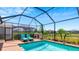 Enclosed pool area with grill and plenty of seating at 15177 Spanish Point Dr, Port Charlotte, FL 33981