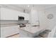 Modern kitchen with white cabinets, granite countertops, and island at 15177 Spanish Point Dr, Port Charlotte, FL 33981