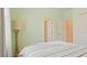 Bedroom with a double bed, tall lamp, and access to other rooms at 15177 Spanish Point Dr, Port Charlotte, FL 33981