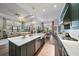 Open kitchen with green cabinetry and island at 284 Bocelli Dr., Nokomis, FL 34275