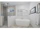 Luxurious bathroom with a freestanding tub, walk-in shower, and marble floors at 284 Bocelli Dr., Nokomis, FL 34275