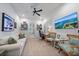 Home office features a comfortable sofa, large TV, and built-in desk at 284 Bocelli Dr., Nokomis, FL 34275