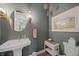 Elegant powder room with a pedestal sink, gold accents, and framed art at 284 Bocelli Dr., Nokomis, FL 34275