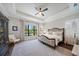 Spacious main bedroom with king-size bed, window seating, and hardwood floors at 284 Bocelli Dr., Nokomis, FL 34275