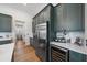 Modern kitchen features stainless steel appliances and green cabinetry at 284 Bocelli Dr., Nokomis, FL 34275