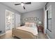 Bedroom with blush-toned bedding and en-suite bathroom at 284 Bocelli Dr., Nokomis, FL 34275