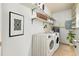 Functional laundry room with new machines and storage shelves at 472 Circlewood Dr # L9, Venice, FL 34293