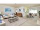 Bright living room with modern furnishings and open dining area at 472 Circlewood Dr # L9, Venice, FL 34293
