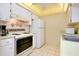 Efficient kitchen with white cabinets and appliances at 472 Circlewood Dr # L9, Venice, FL 34293