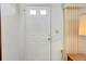 White front door with glass panels and sidelights, welcoming entryway at 472 Circlewood Dr # L9, Venice, FL 34293
