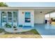Front view of a single story home with carport and landscaped yard at 472 Circlewood Dr # L9, Venice, FL 34293
