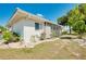 Side view of a single story home with screened patio and landscaping at 472 Circlewood Dr # L9, Venice, FL 34293