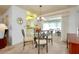 Dining area with glass-top table and four chairs at 472 Circlewood Dr # L9, Venice, FL 34293