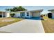 Front view of a single story home with carport and landscaped yard at 472 Circlewood Dr # L9, Venice, FL 34293