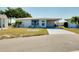 Front view of a single story home with carport and landscaped yard at 472 Circlewood Dr # L9, Venice, FL 34293