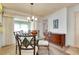 Bright dining room with wood buffet and glass table at 472 Circlewood Dr # L9, Venice, FL 34293