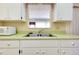 Kitchen features double sink and pass-through window at 472 Circlewood Dr # L9, Venice, FL 34293