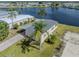 An aerial view of a house situated on a waterfront lot in a residential community at 109 Lakeview Dr, North Port, FL 34287